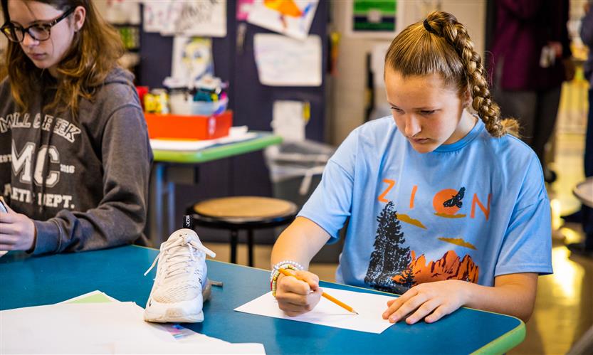 Students sketch shoes during art class